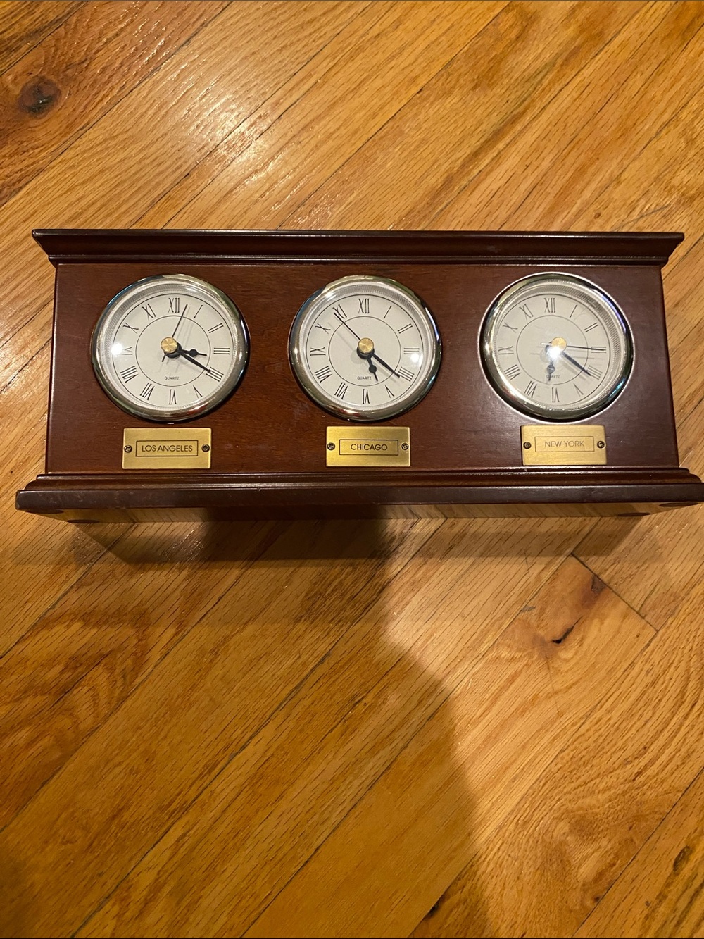 The Bombay Company Triple-Dial Wooden Clock in Dark Brown and silver.